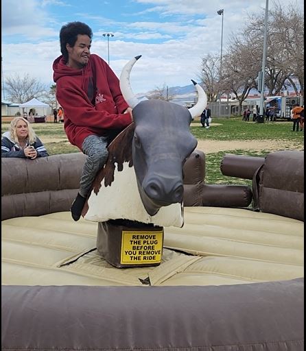 Rider on the PDOP mechanical riding bull at a Pahrump event